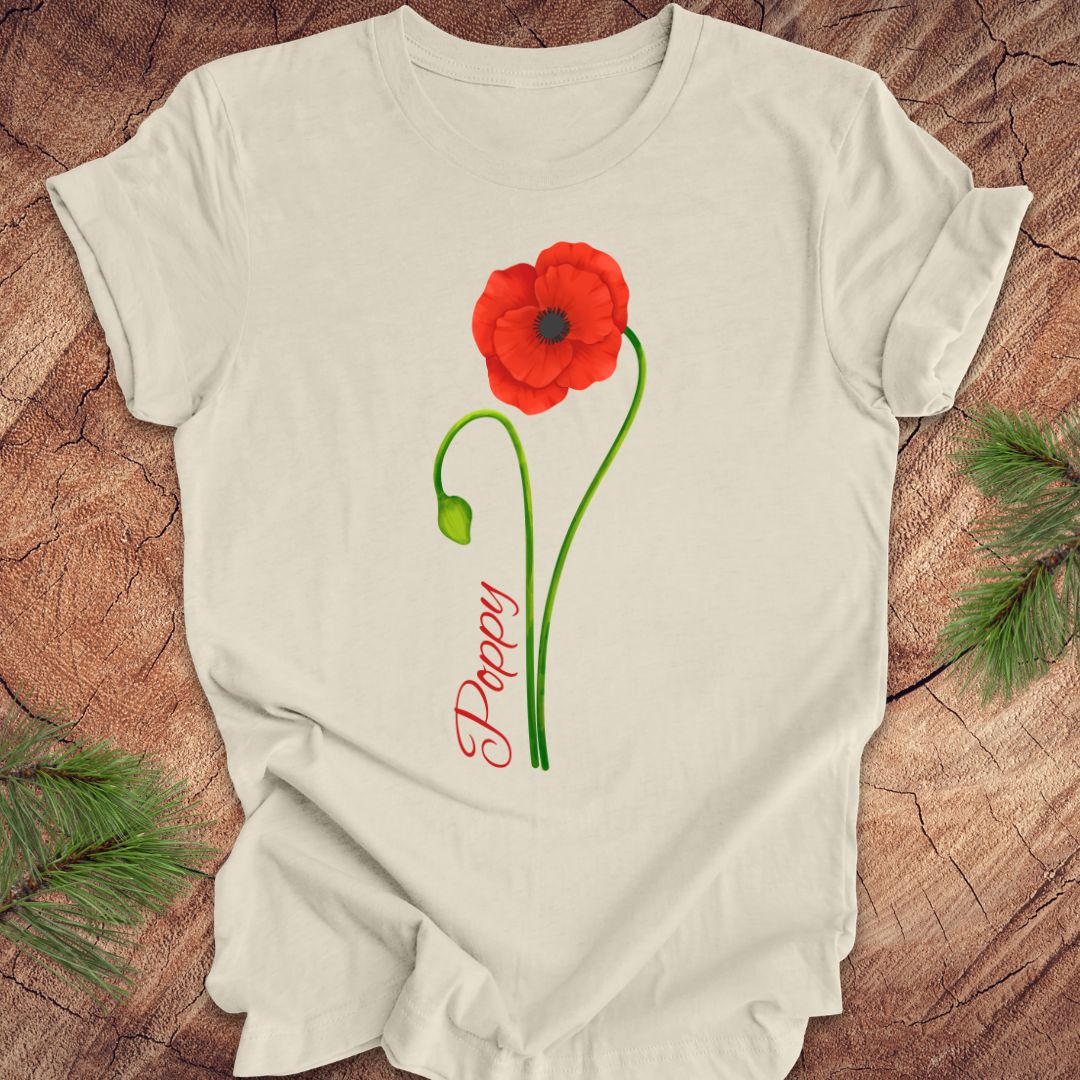 Beige t-shirt with red poppy design and 'Daddy' text on a wooden surface