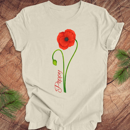 Beige t-shirt with red poppy design and 'Daddy' text on a wooden surface