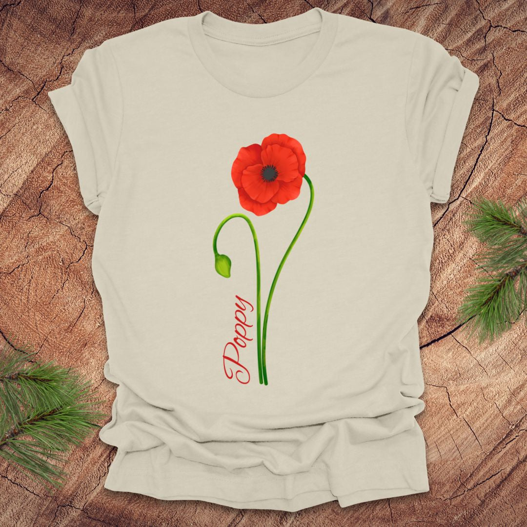 Beige t-shirt with red poppy flower design on a wooden surface