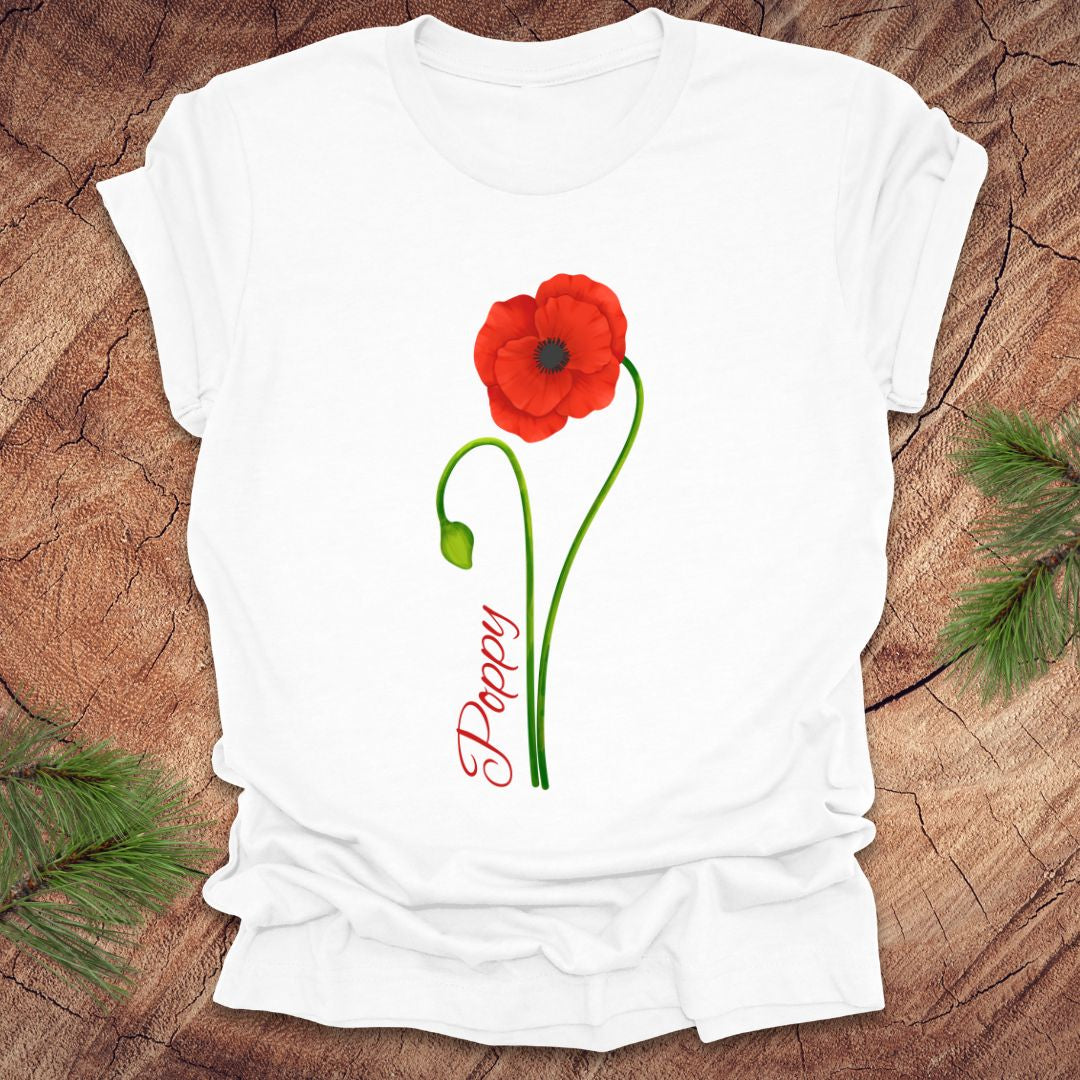 White t-shirt with red poppy flower design on a wooden surface