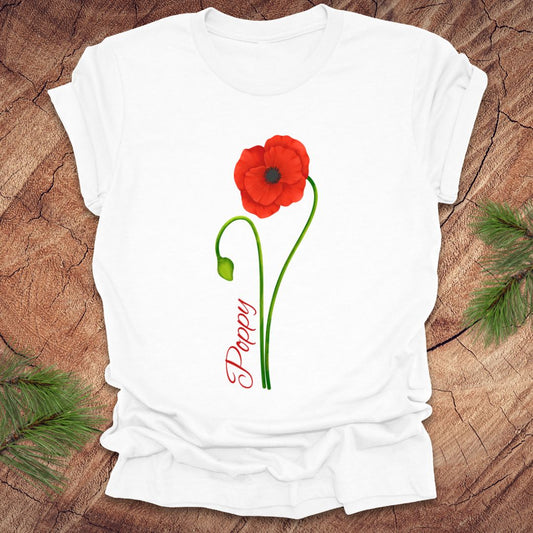 White t-shirt with red poppy flower design on a wooden surface