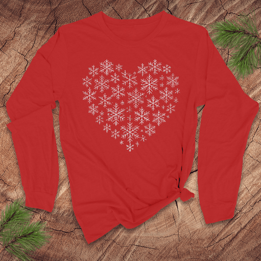 Red long-sleeve t-shirt with snowflakes making the shape of a heart on a wood background.