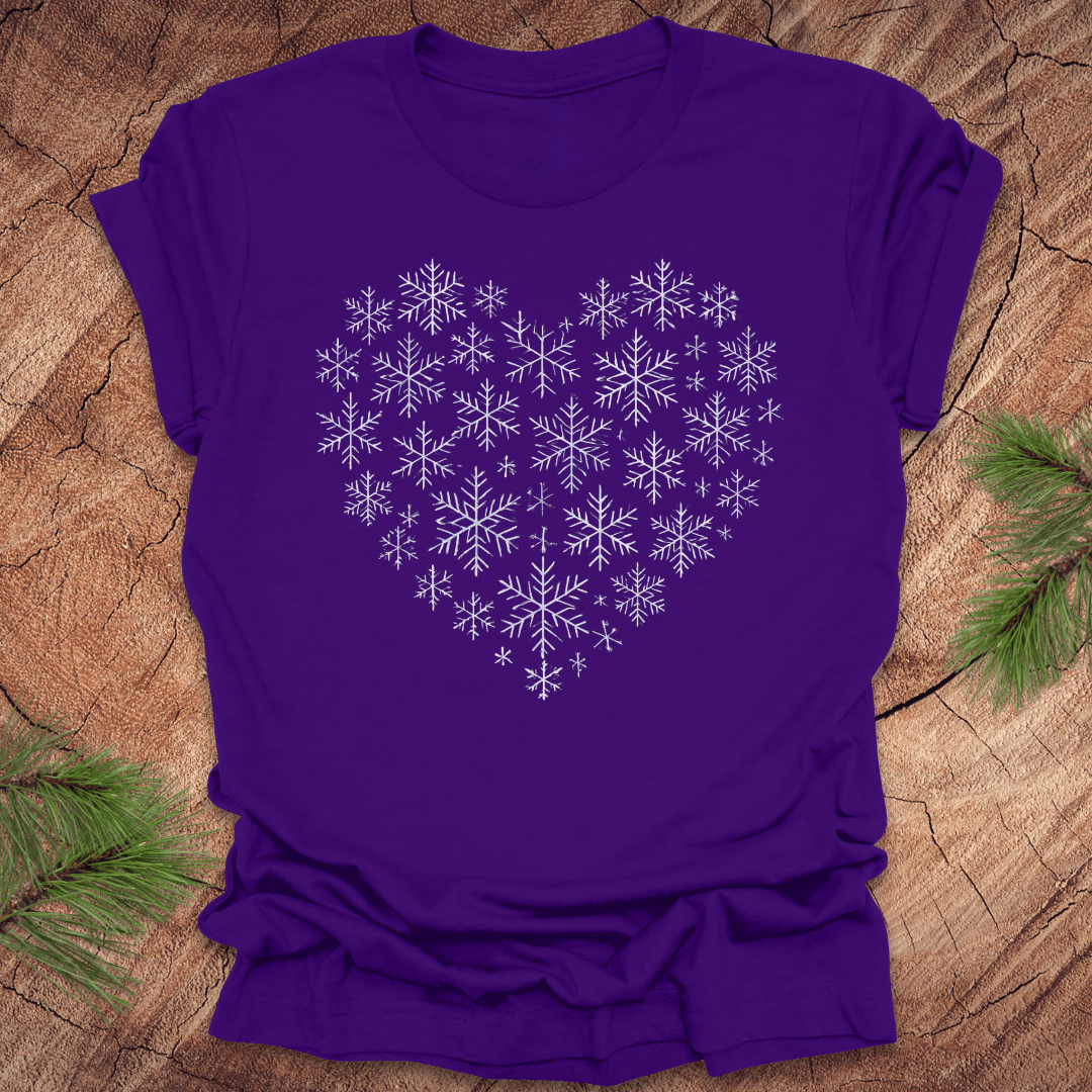 Purple t-shirt with snowflakes making the shape of a heart on a wood background.