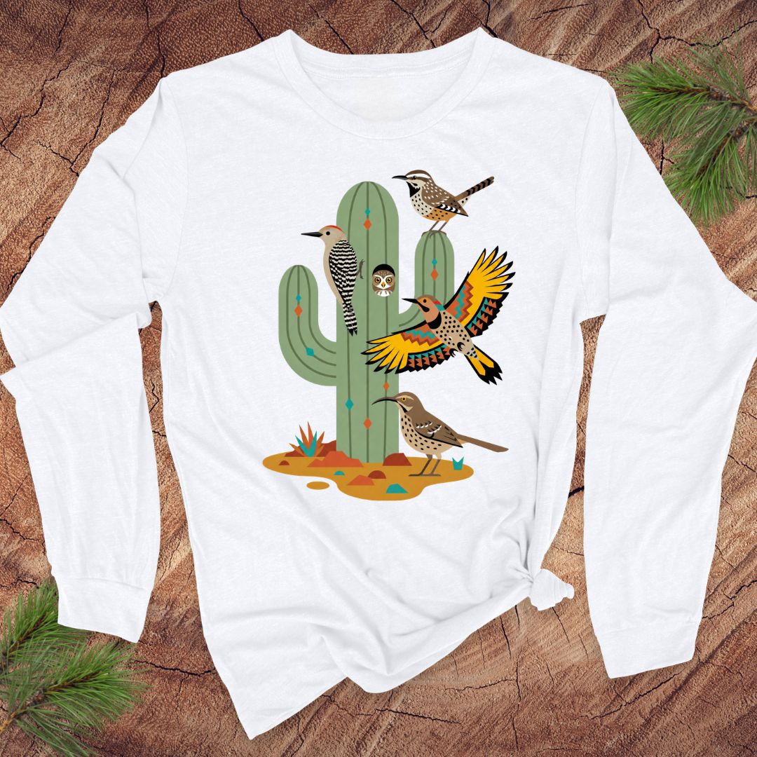 White long-sleeve t-shirt with birds and a cactus on a wood background.