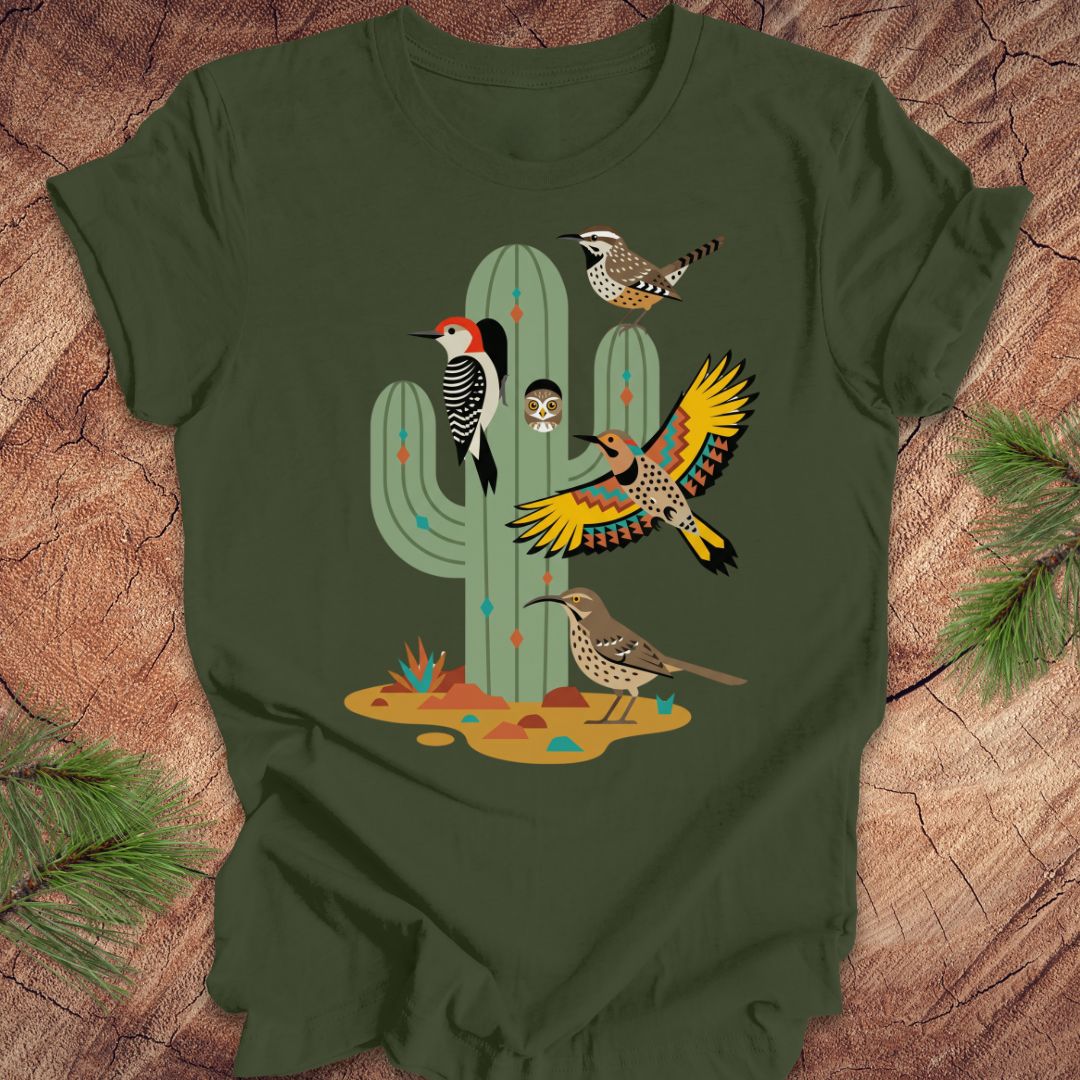 Green t-shirt with cactus and birds design on a wooden surface
