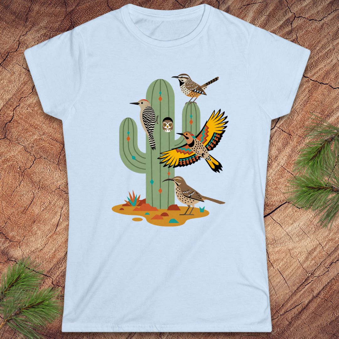 Blue t-shirt with a cactus and birds on a wood background.