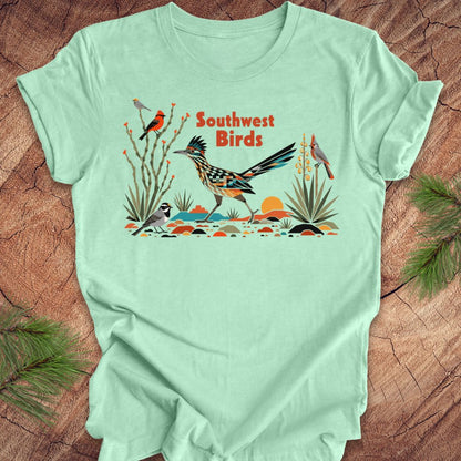 Mint green t-shirt with 'Southwest Birds' graphic on a wooden surface