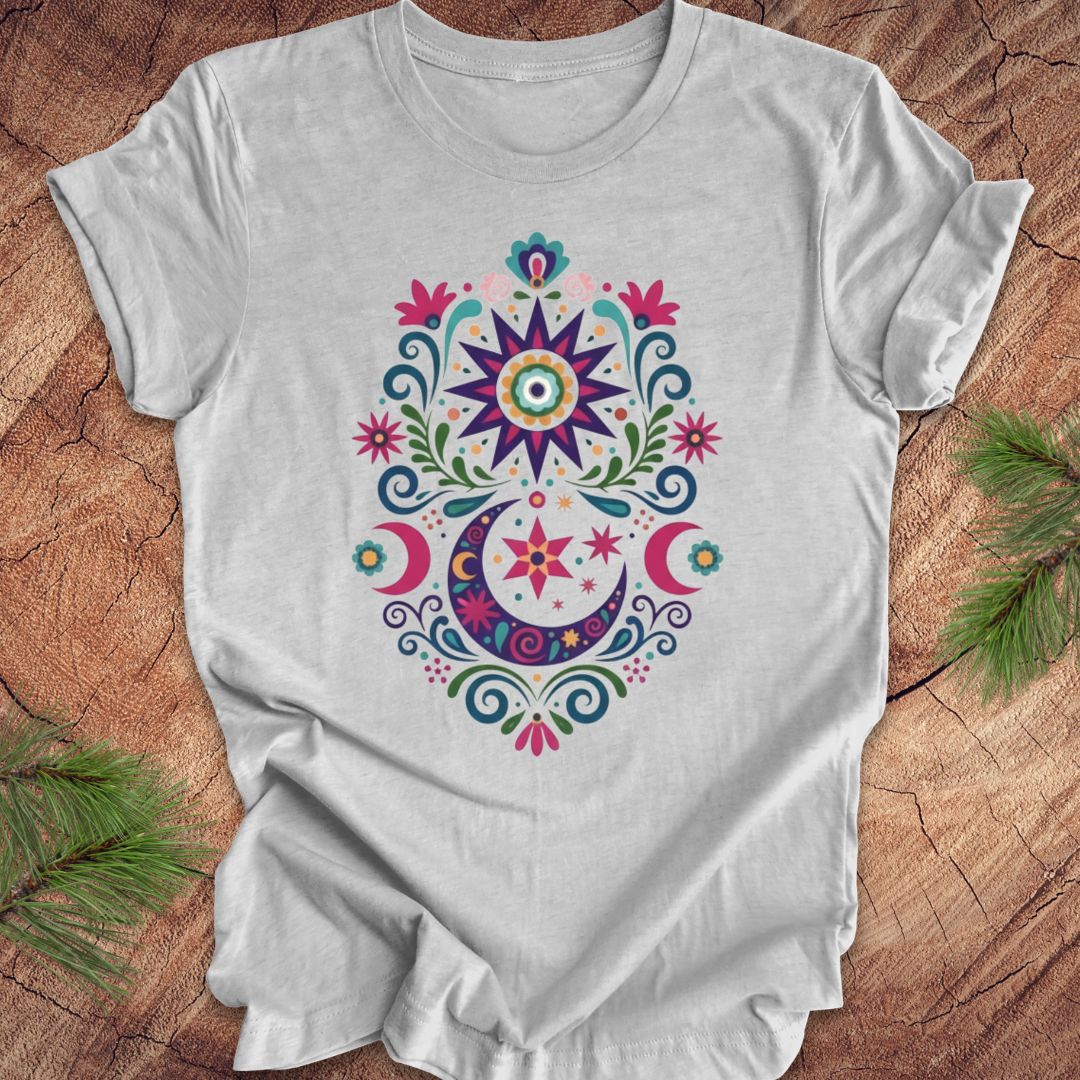 Gray t-shirt with colorful floral design on a wooden surface