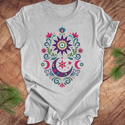 Gray t-shirt with colorful floral design on a wooden surface