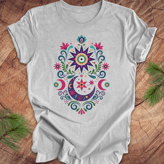 Gray t-shirt with colorful floral design on a wooden surface