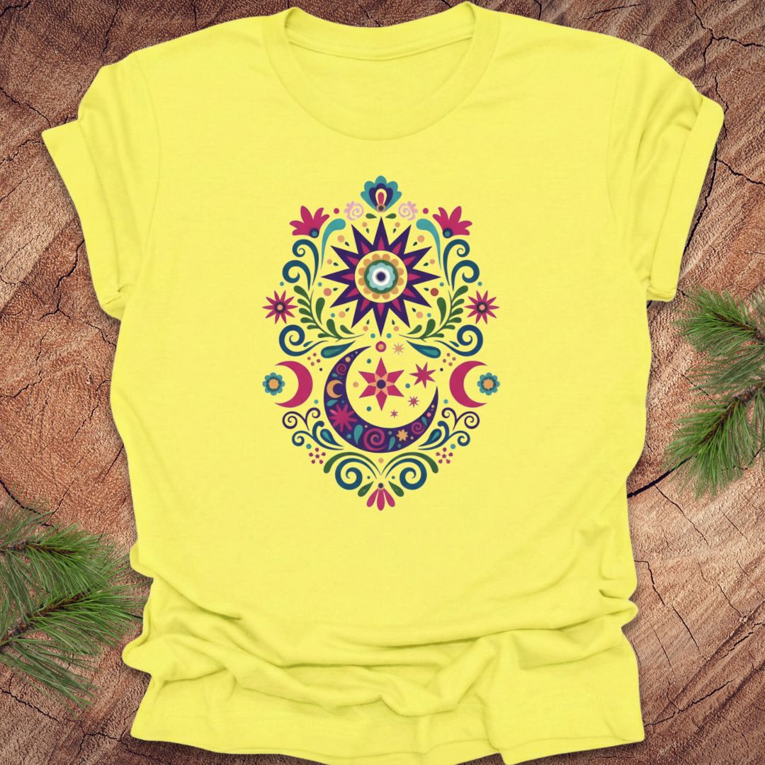Yellow t-shirt with a colorful mandala design on a wooden surface