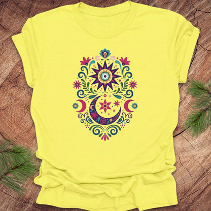Yellow t-shirt with a colorful mandala design on a wooden surface
