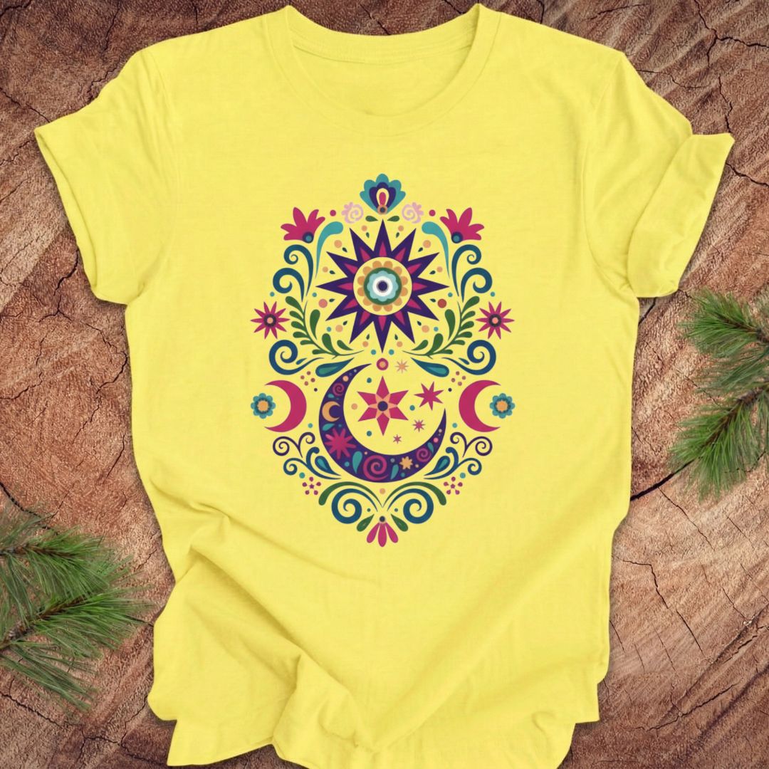 Yellow t-shirt with a colorful mandala design on a wooden surface