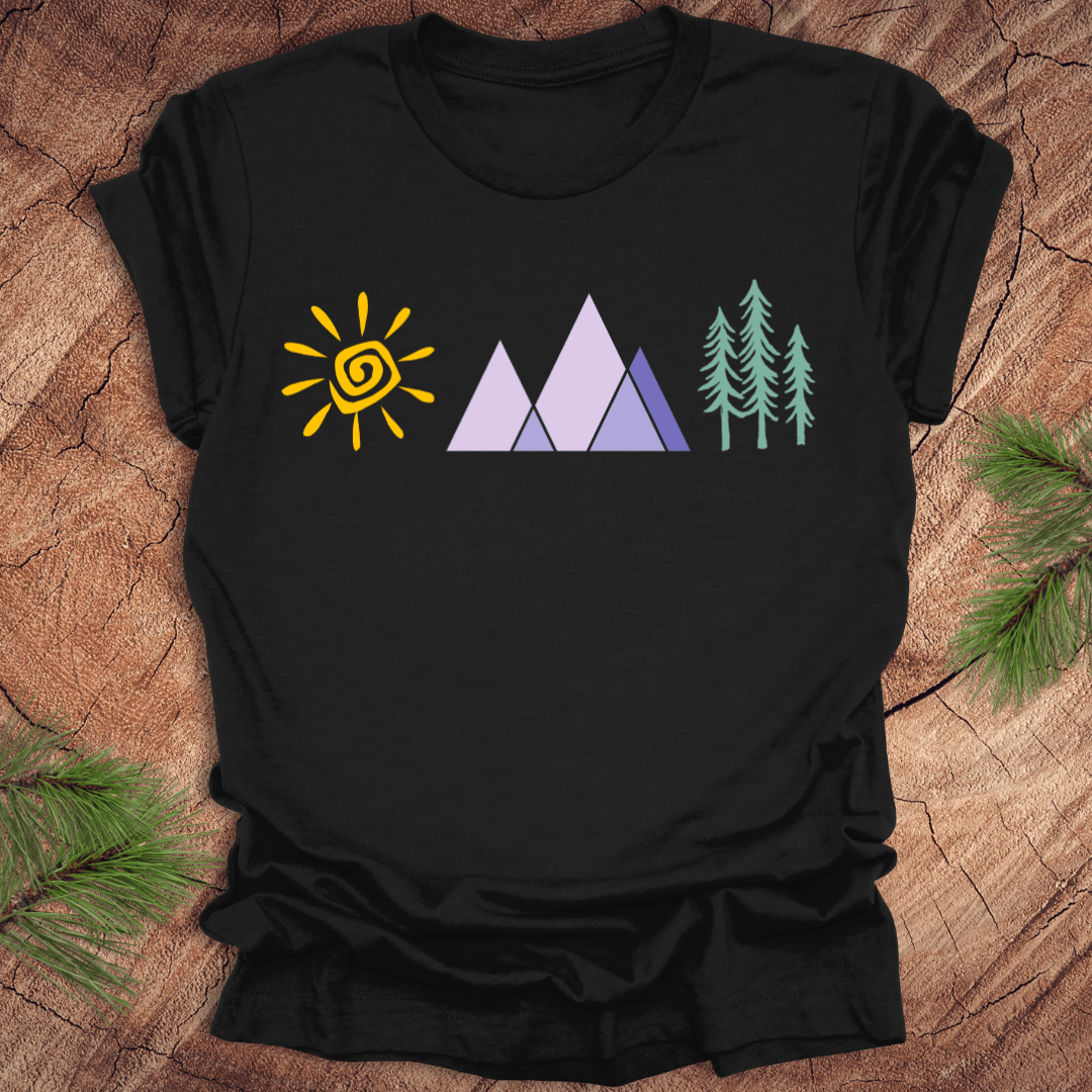 Black t-shirt with sun, mountain, and tree graphics on a wooden surface.