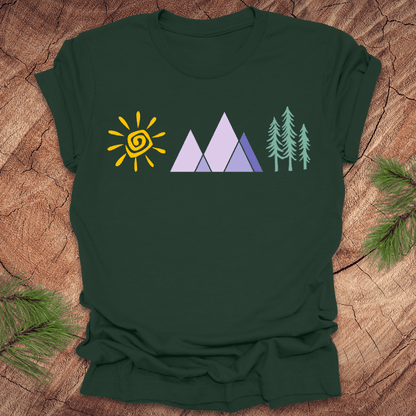Forest green t-shirt with nature-themed design on a wooden surface
