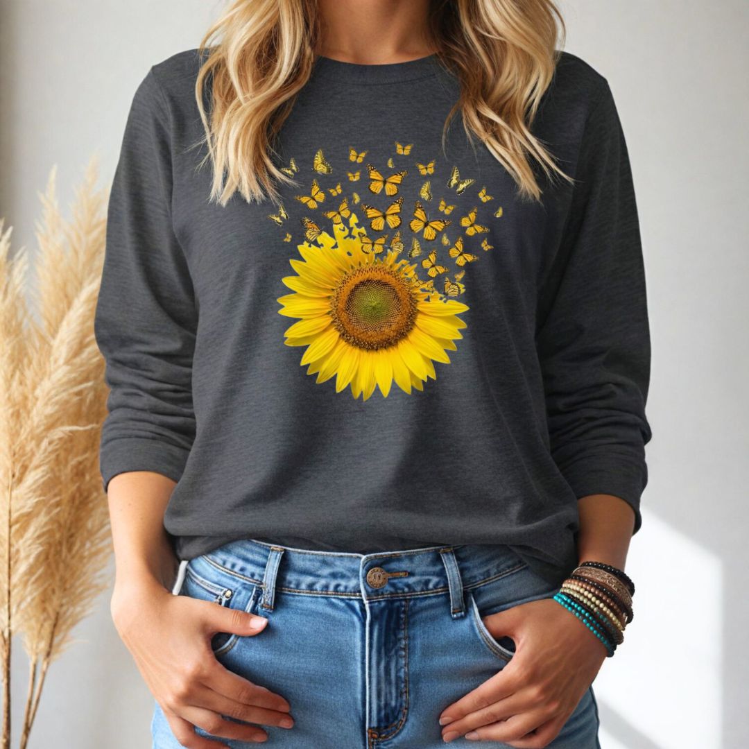 Person wearing a dark gray long aleeve shirt with a sunflower and butterfly design, standing against a neutral background.