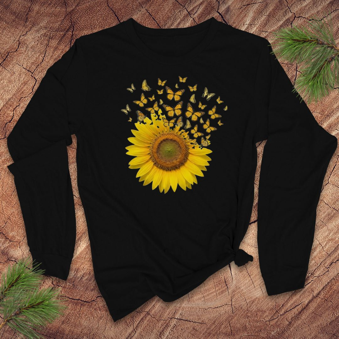 Black long-sleeve shirt with a sunflower and butterfly design on a wooden surface.