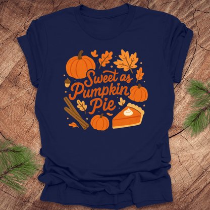 Navy blue t-shirt with 'Sweet as Pumpkin Pie' design on a wooden surface with leaves.