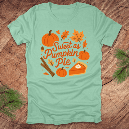 Mint green t-shirt with pumpkin pie design on a wooden surface