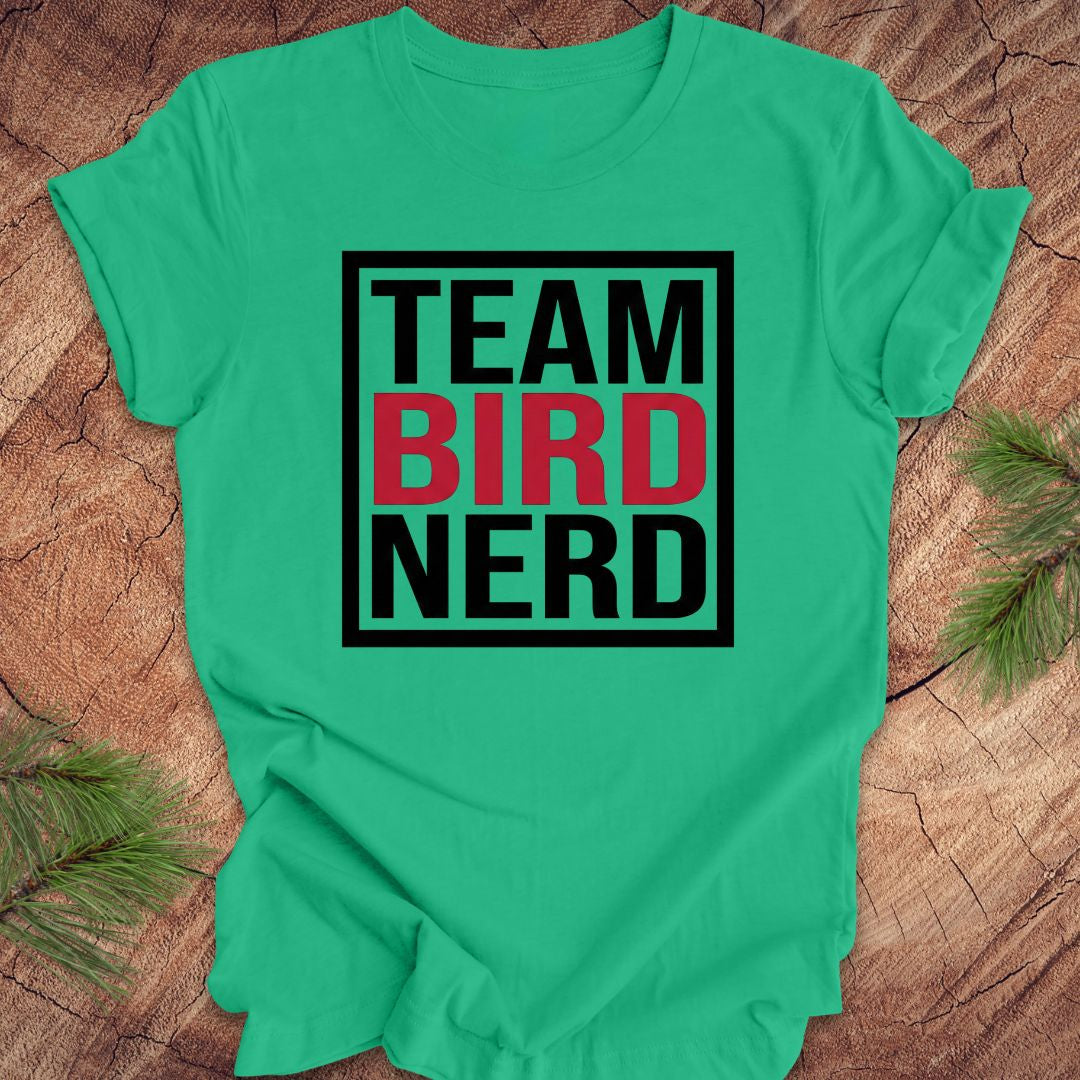 Green t-shirt with 'Team Bird Nerd' text on a wooden surface
