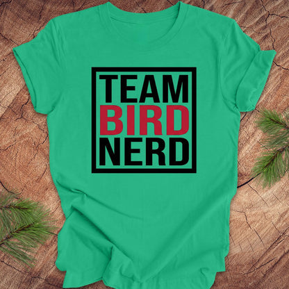 Green t-shirt with 'Team Bird Nerd' text on a wooden surface