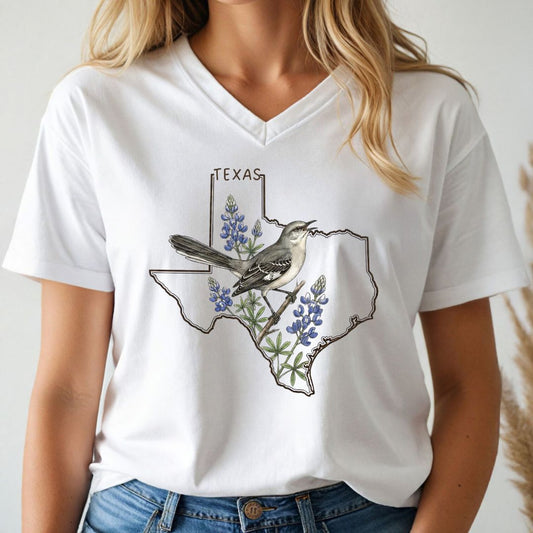 Person wearing a white t-shirt with a Texas map and bird design.