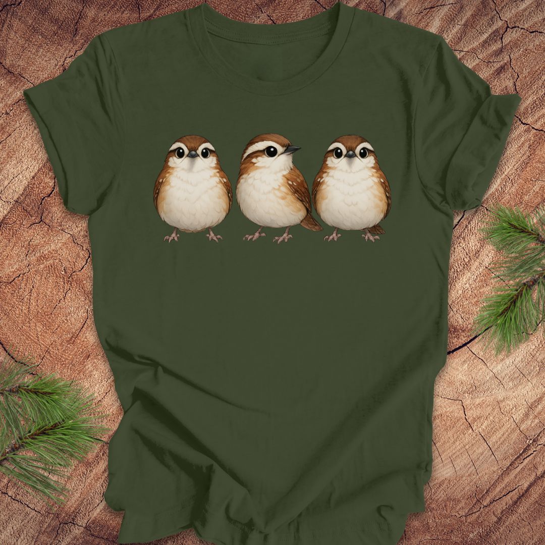 Green t-shirt with three carolina wren birds on a wooden surface