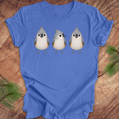 Blue t-shirt with 3 titmouses design on a wooden surface
