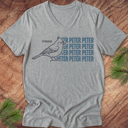 Gray vneck t-shirt with blue "Peter" text and titmouse illustration on a wooden surface