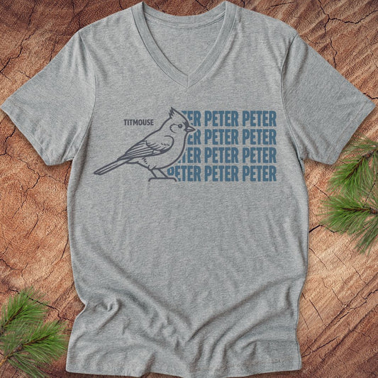 Gray vneck t-shirt with blue "Peter" text and titmouse illustration on a wooden surface