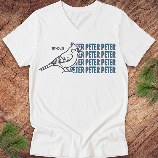 White vneck t-shirt with blue "Peter" text and titmouse illustration on a wooden surface
