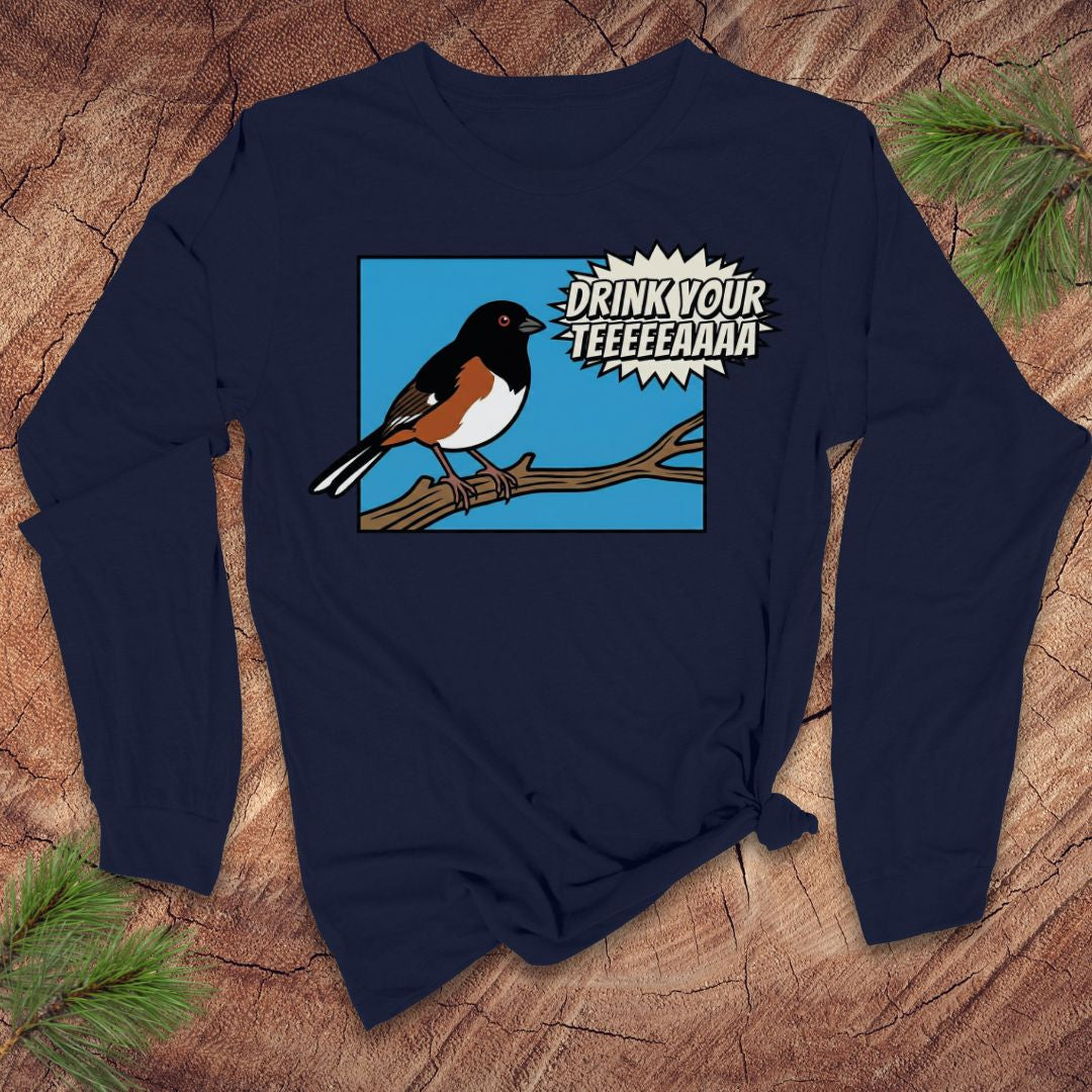 Navy blue long-sleeve shirt with a towhee bird graphic and text, 'drink your tea' on a wooden surface.