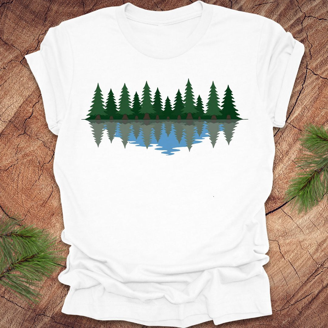 White t-shirt with a forest design on a wooden surface