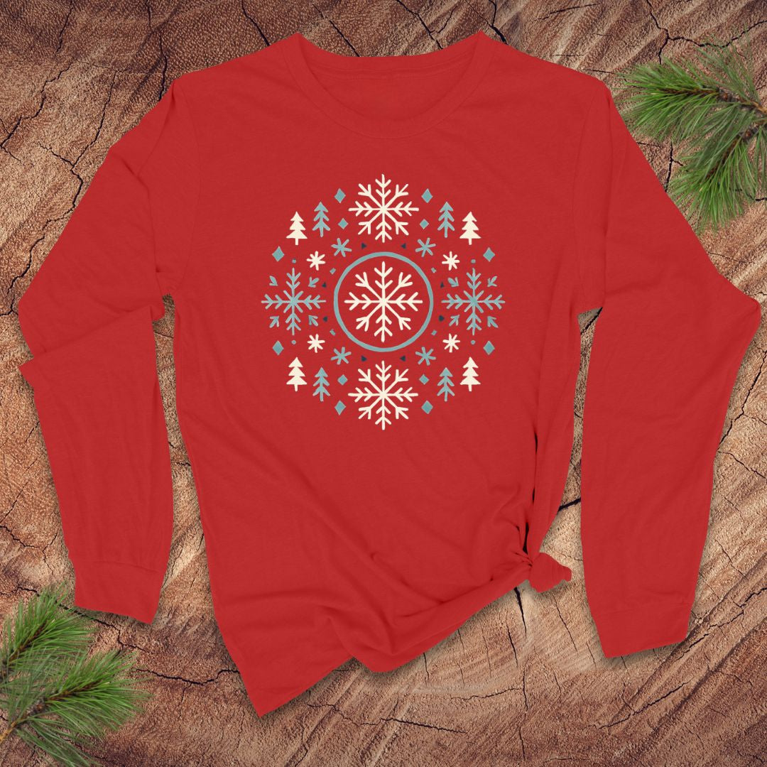 Red long-sleeve shirt with a snowflake and tree design on a wooden surface