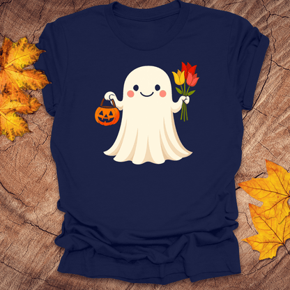 Navy blue t-shirt with a ghost holding a pumpkin and flowers on a wooden surface with fall leaves.