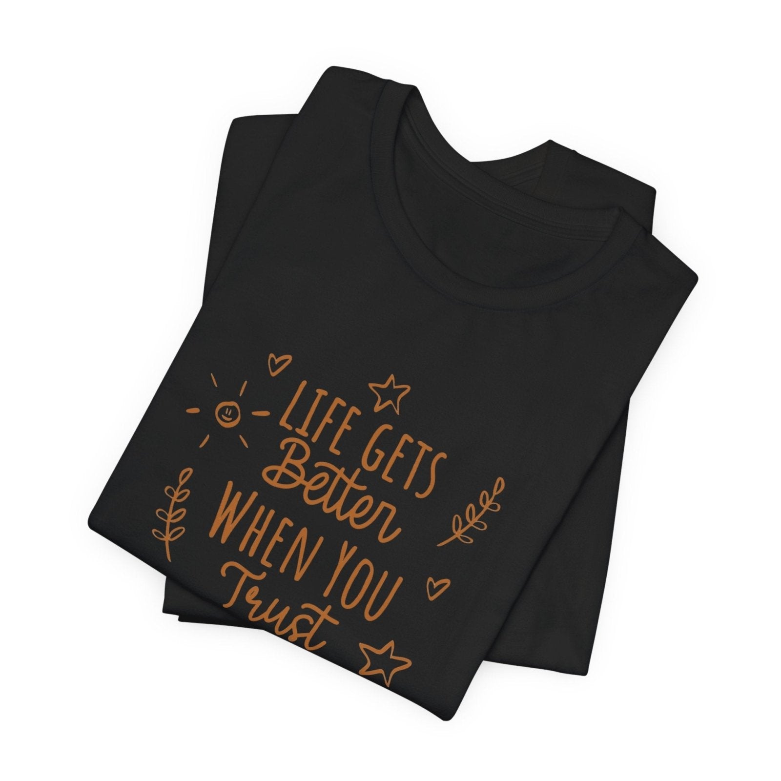 Black folded t-shirt with motivational quote on a white background