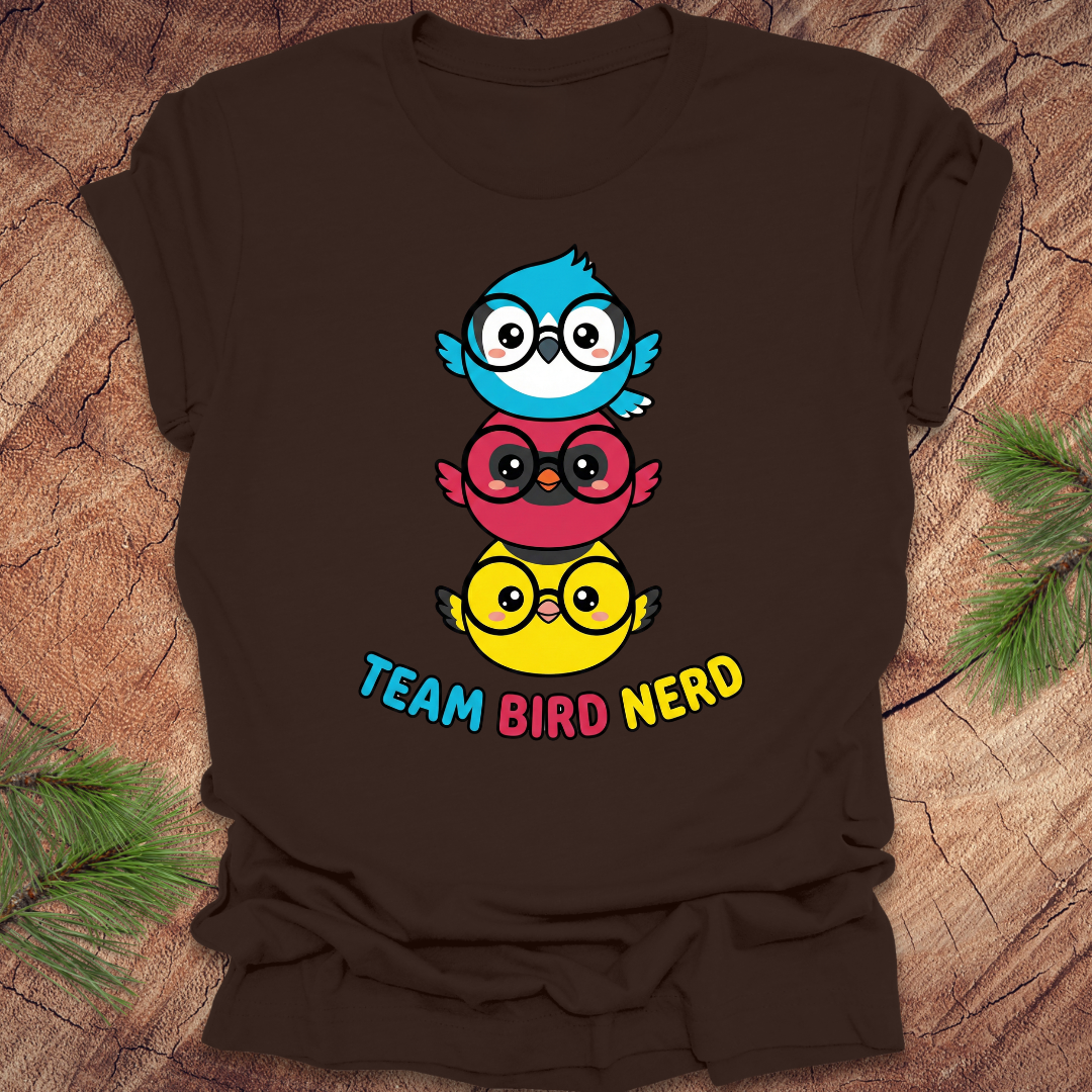 Brown t-shirt with colorful birds and 'Team Bird Nerd' text on a wooden surface.