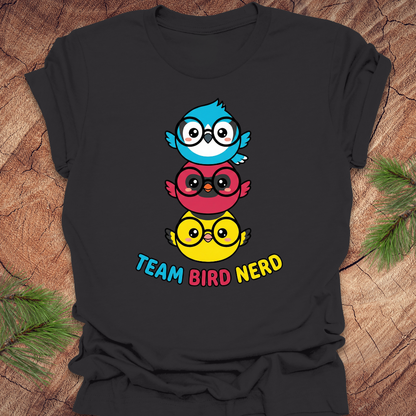 Dark gray t-shirt with colorful birds and 'Team Bird Nerd' text on a wooden surface.