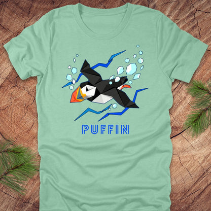 Light green t-shirt with a puffin graphic and 'PUFFIN' text on a wooden surface.