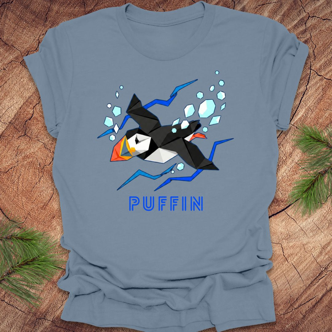 Blue t-shirt with a puffin graphic and 'PUFFIN' text on a wooden surface.