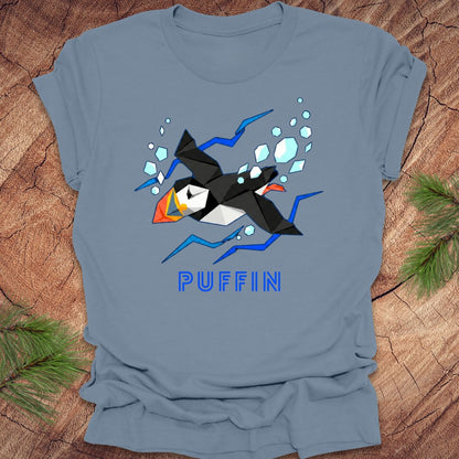 Blue t-shirt with a puffin graphic and 'PUFFIN' text on a wooden surface.