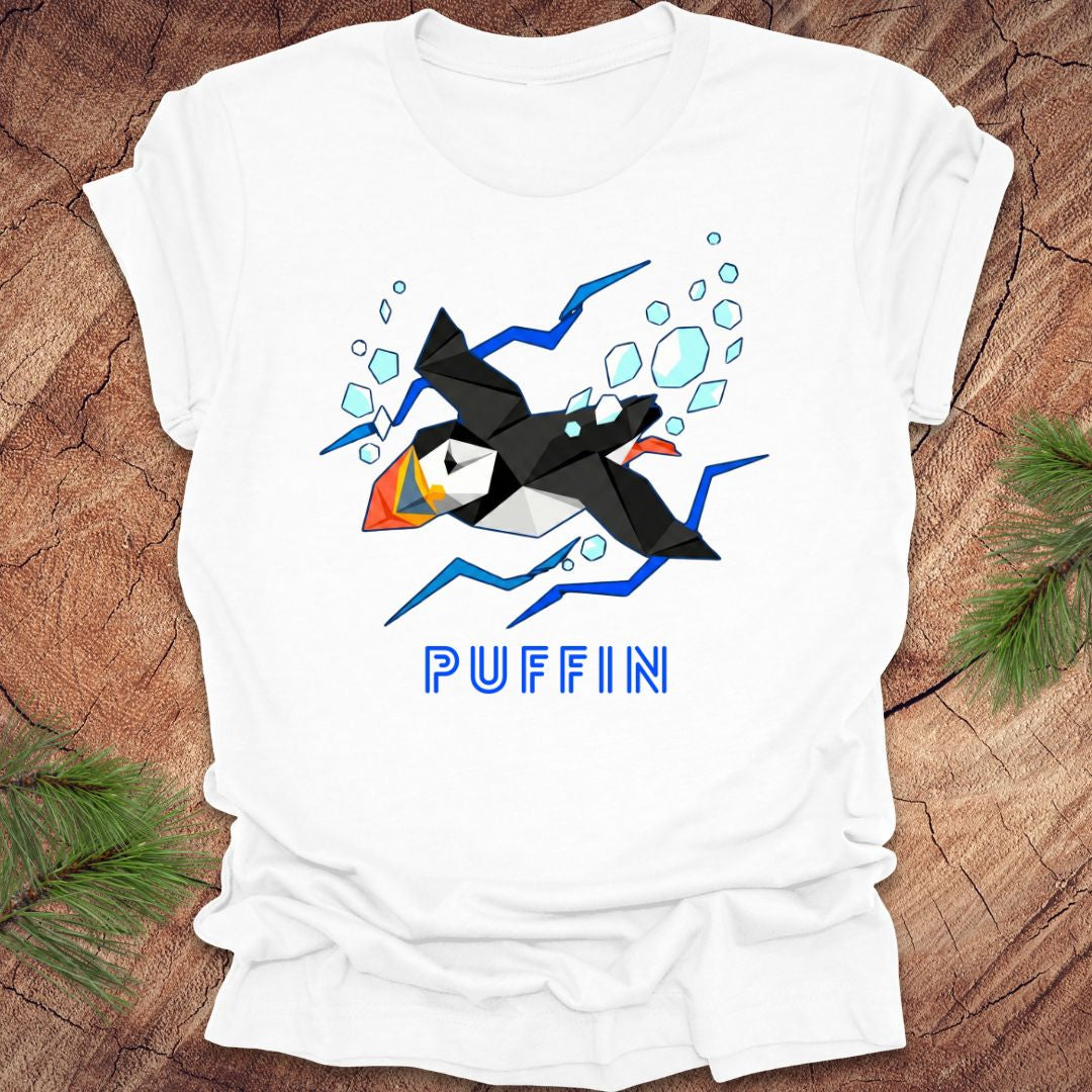 White t-shirt with puffin graphic and 'PUFFIN' text on a wooden surface
