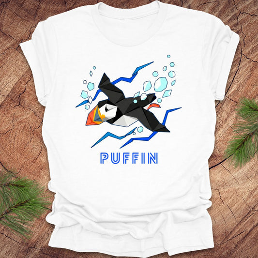 White t-shirt with puffin graphic and 'PUFFIN' text on a wooden surface