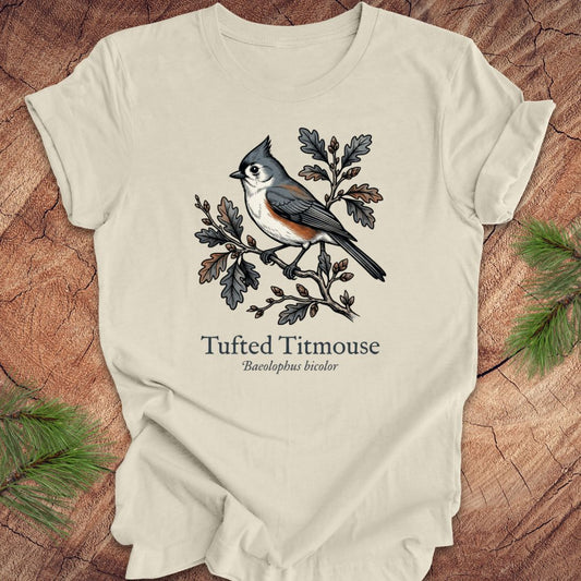 Beige t-shirt with tufted titmouse design on a wooden surface
