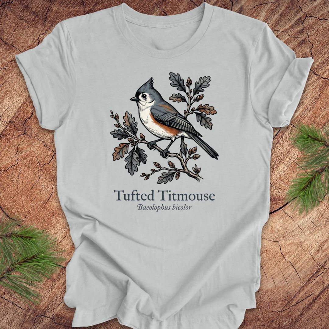 Gray  t-shirt with tufted titmouse illustration and text on a wooden surface