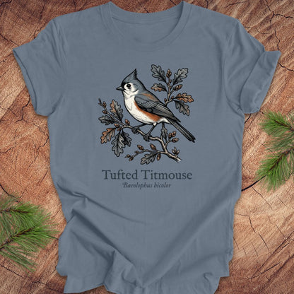 Blue t-shirt with tufted titmouse design on a wooden surface