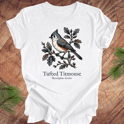 White t-shirt with tufted titmouse design on a wooden surface