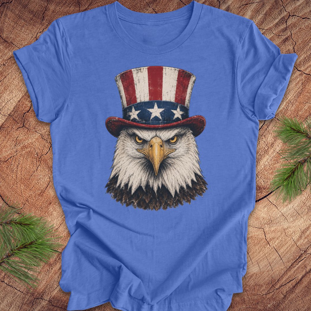 Blue t-shirt with an eagle wearing an Uncle Sam hat on a wooden surface