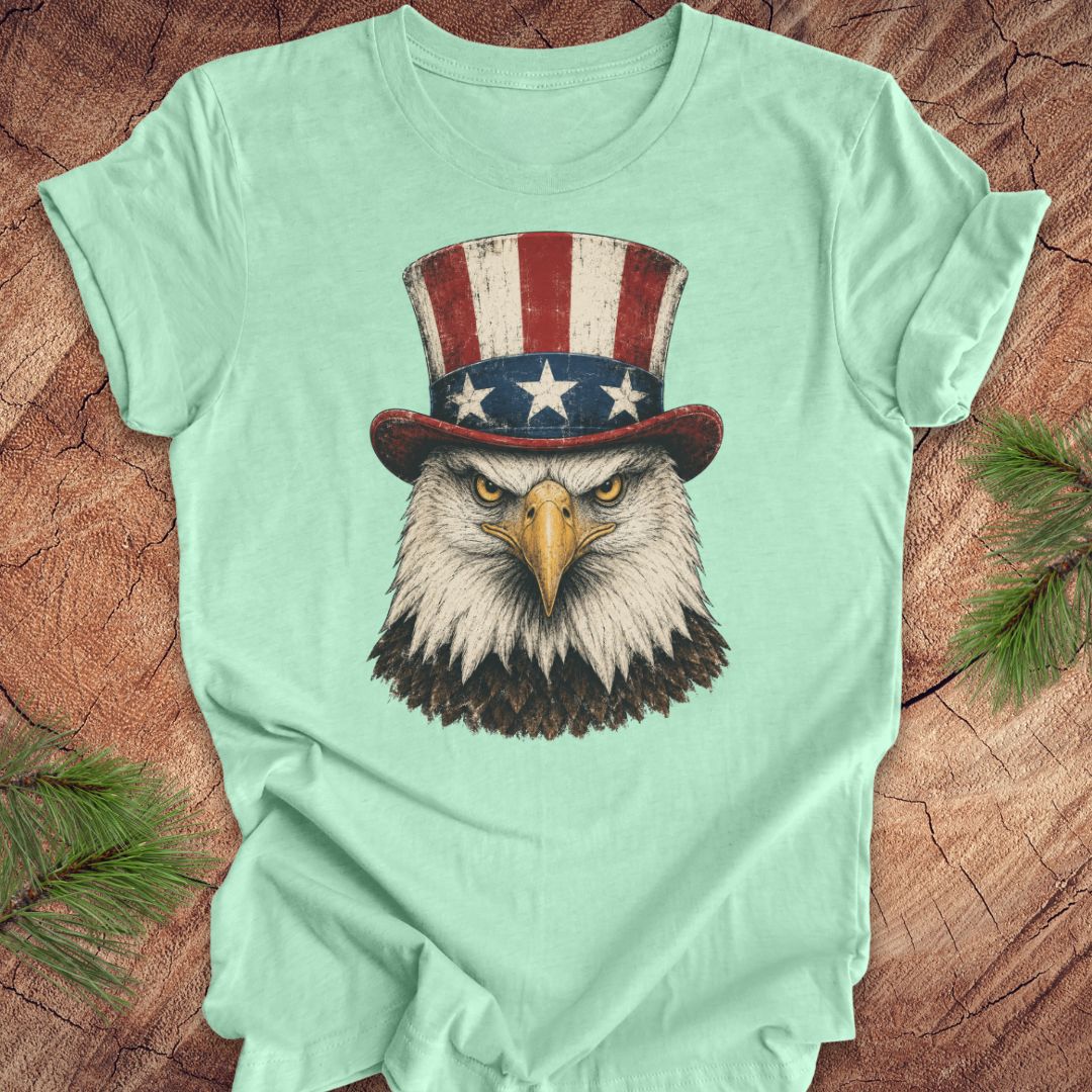 Mint green t-shirt with an eagle wearing an Uncle Sam hat on a wooden surface