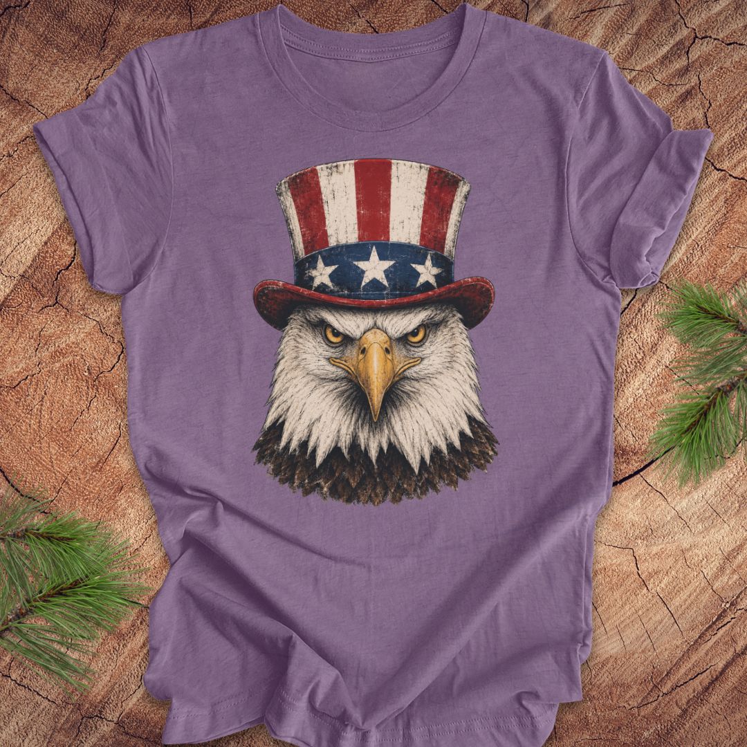 Purple t-shirt with an eagle wearing an Uncle Sam hat on a wooden surface